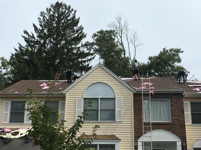 Our diligent workers putting in the shingles